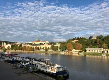 Arch bridge over river against buildings in city