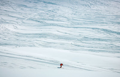 High angle view of person skiing on snowcapped mountain