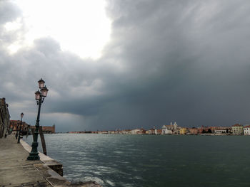 Panoramic view of sea and buildings against sky