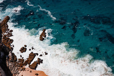 High angle view of rocks in sea