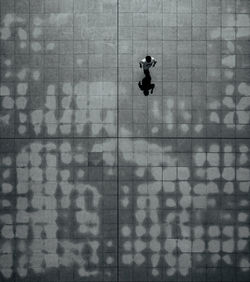 High angle view of man walking on footpath
