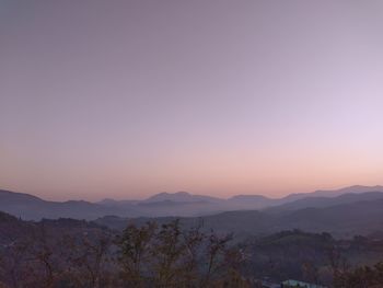 Scenic view of mountains against clear sky during sunset