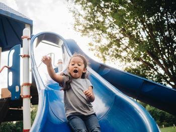 Full length of girl on slide