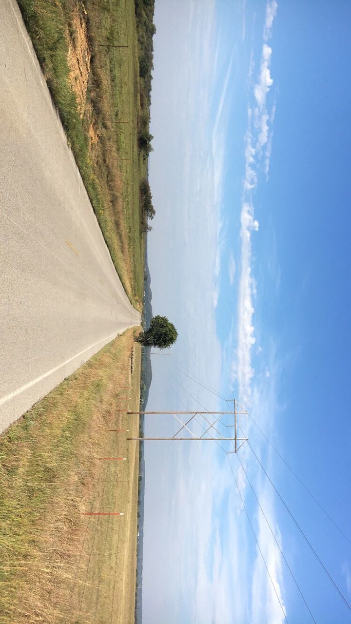 road, sky, the way forward, road marking, landscape, transportation, country road, day, long, surface level, blue, tranquil scene, remote, tranquility, cloud, outdoors, nature, vanishing point, cloud - sky, mountain, scenics, countryside, diminishing perspective, white line, mountain range, in front of, beauty in nature, solitude