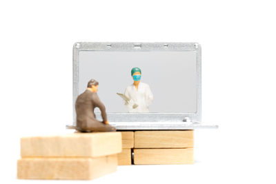 Children playing with toy against white background