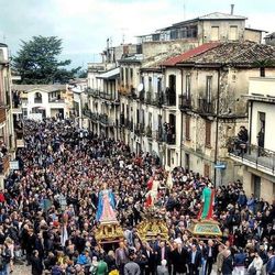 People on street against buildings in city