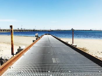 Pier over sea against clear sky