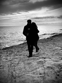 Rear view of couple on beach