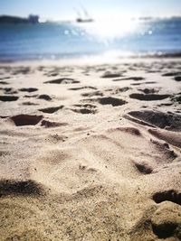 Close-up of sand on beach against sky