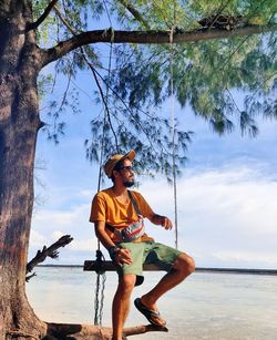 Man standing by sea against sky