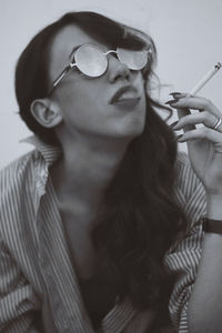 Young woman smoking cigarette 