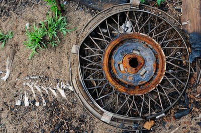 High angle view of rusty wheel on field