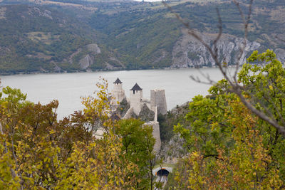 Scenic view of trees and buildings against mountains