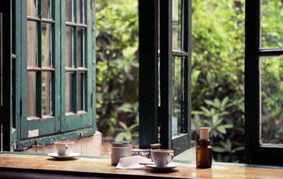 Glass of coffee cup on table by window