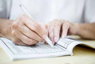 Close-up of senior woman doing a crossword puzzle