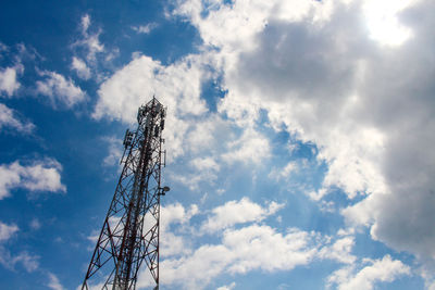 Low angle view of communications tower against sky