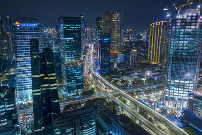 Illuminated modern buildings in city at night