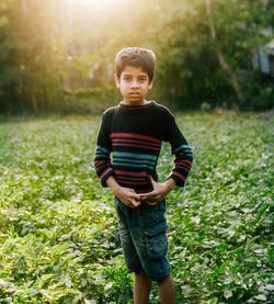 Portrait of boy standing on field