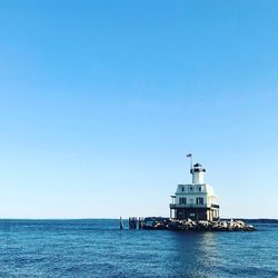 Scenic view of sea against clear blue sky