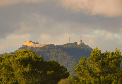 Panoramic view of trees and buildings against sky