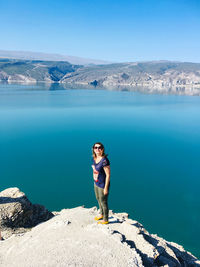 Full length of woman on sea against mountain