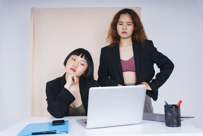 Lesbian couple working in office