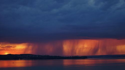 Scenic view of dramatic sky over sea during sunset