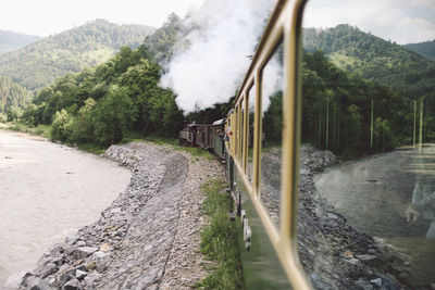 Old-fashioned locomotive train emitting smoke