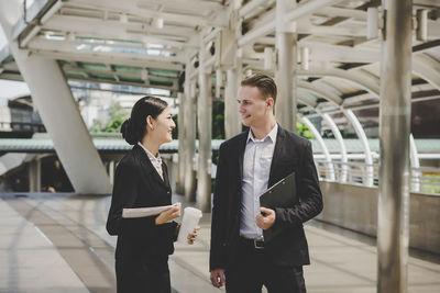 Business people talking while standing outdoors