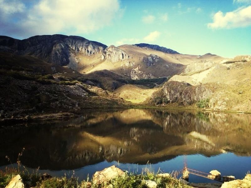 mountain, water, tranquil scene, tranquility, scenics, lake, sky, beauty in nature, reflection, mountain range, nature, non-urban scene, rock formation, rock - object, landscape, physical geography, idyllic, cloud - sky, river, geology