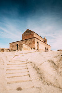 View of old ruin building against cloudy sky