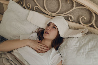 Portrait of young woman sleeping on bed at home