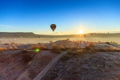 Hot air balloon flying over landscape