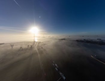 Scenic view of beach against sky at sunset on a misty morning