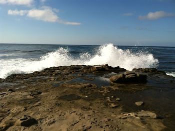 Scenic view of sea waves against sky