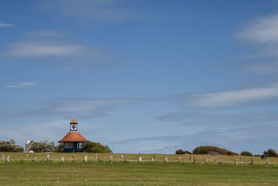 Built structure on field against sky