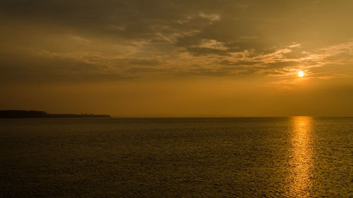 Scenic view of calm sea at sunset