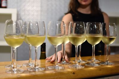 Close-up of woman holding wine glasses