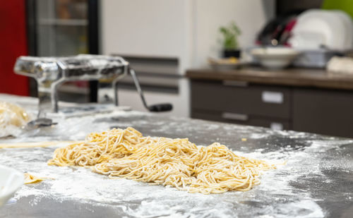 Raw homemade pasta on wooden cutting board. uncooked fresh pasta