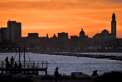 Silhouette of buildings against sky during sunset