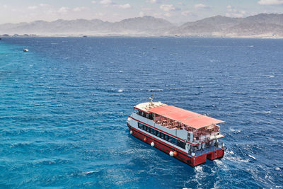 High angle view of boat sailing in sea against sky