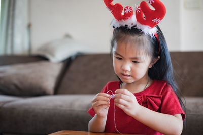 Cute girl doing craft at home