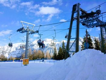 Low angle view of ski lift against sky