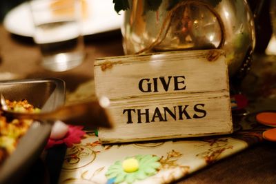 Close-up of thank you sign on table