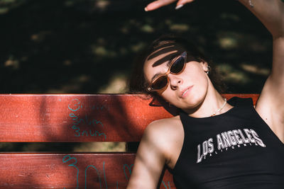 Portrait of young woman wearing sunglasses and looking away