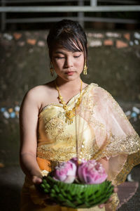 Portrait of young woman standing in temple