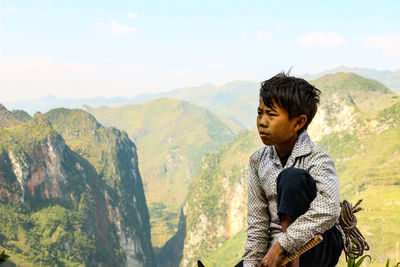 Young man standing on mountain