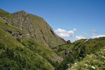 Scenic view of mountains against blue sky