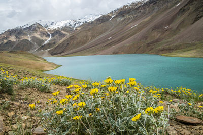 Scenic view of lake and mountains against cloudy sky