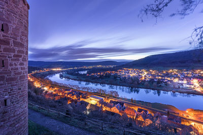 High angle view of illuminated city against sky at night